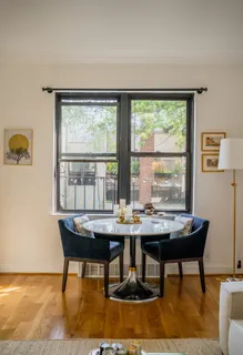 a view of a workspace room with furniture and window