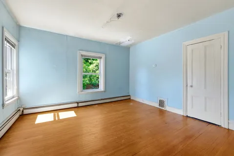 a view of a room with wooden shelves