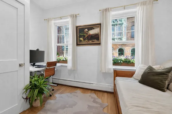 a bedroom with a bed and large window