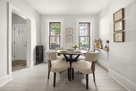 a view of a dining room with furniture and wooden floor