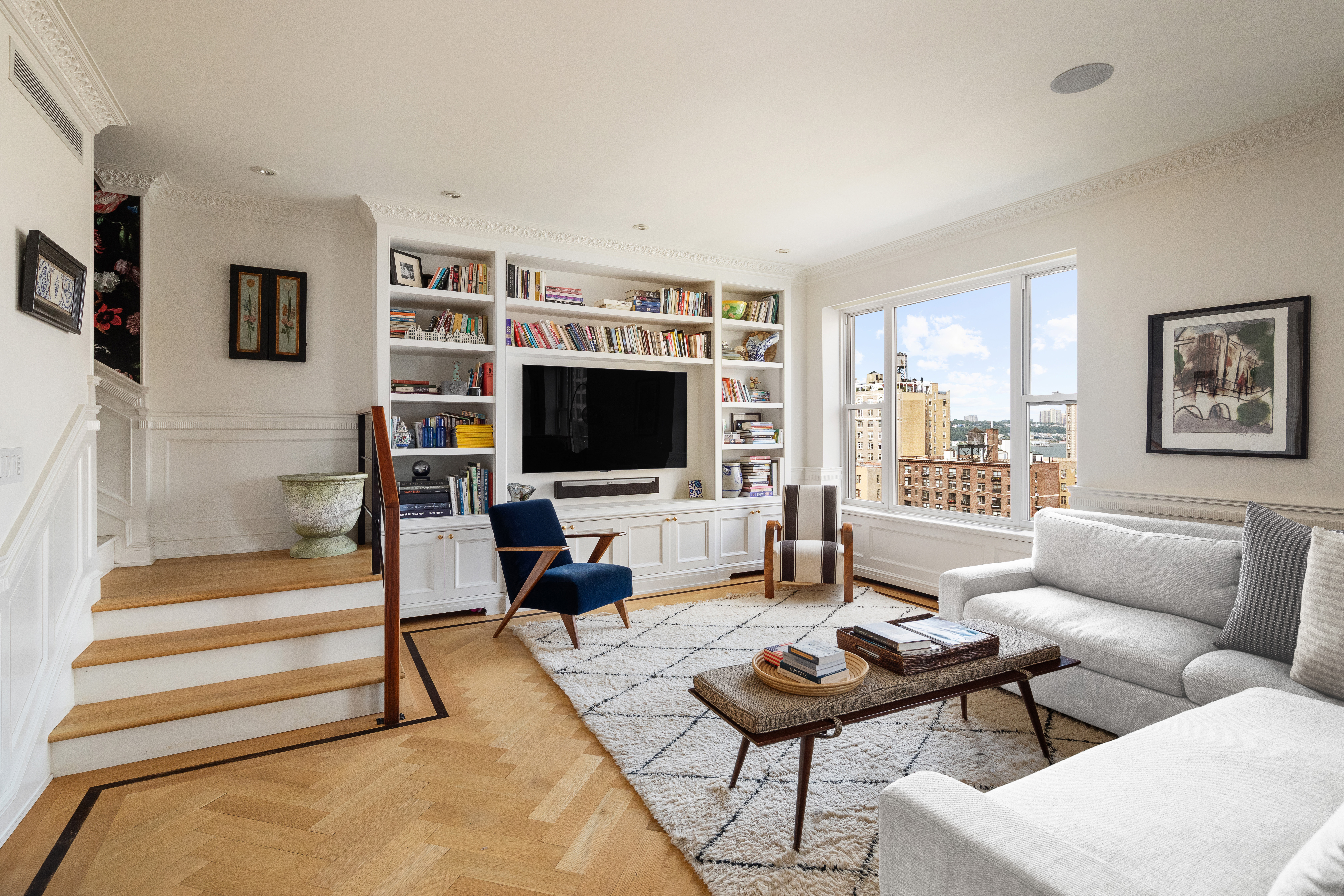 309 West 86th Street, Unit PH Manhattan, NY 10024 - Photo 2 of 16 a living room with furniture and a flat screen tv