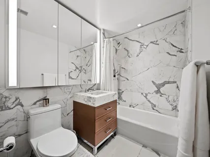 a bathroom with a sink toilet and shower