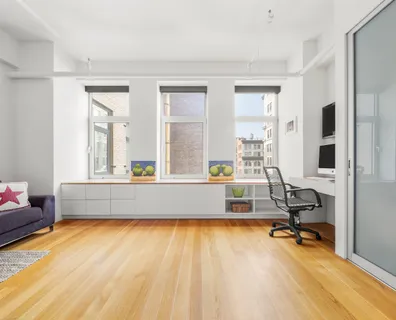 a living room with patio furniture and floor to ceiling window
