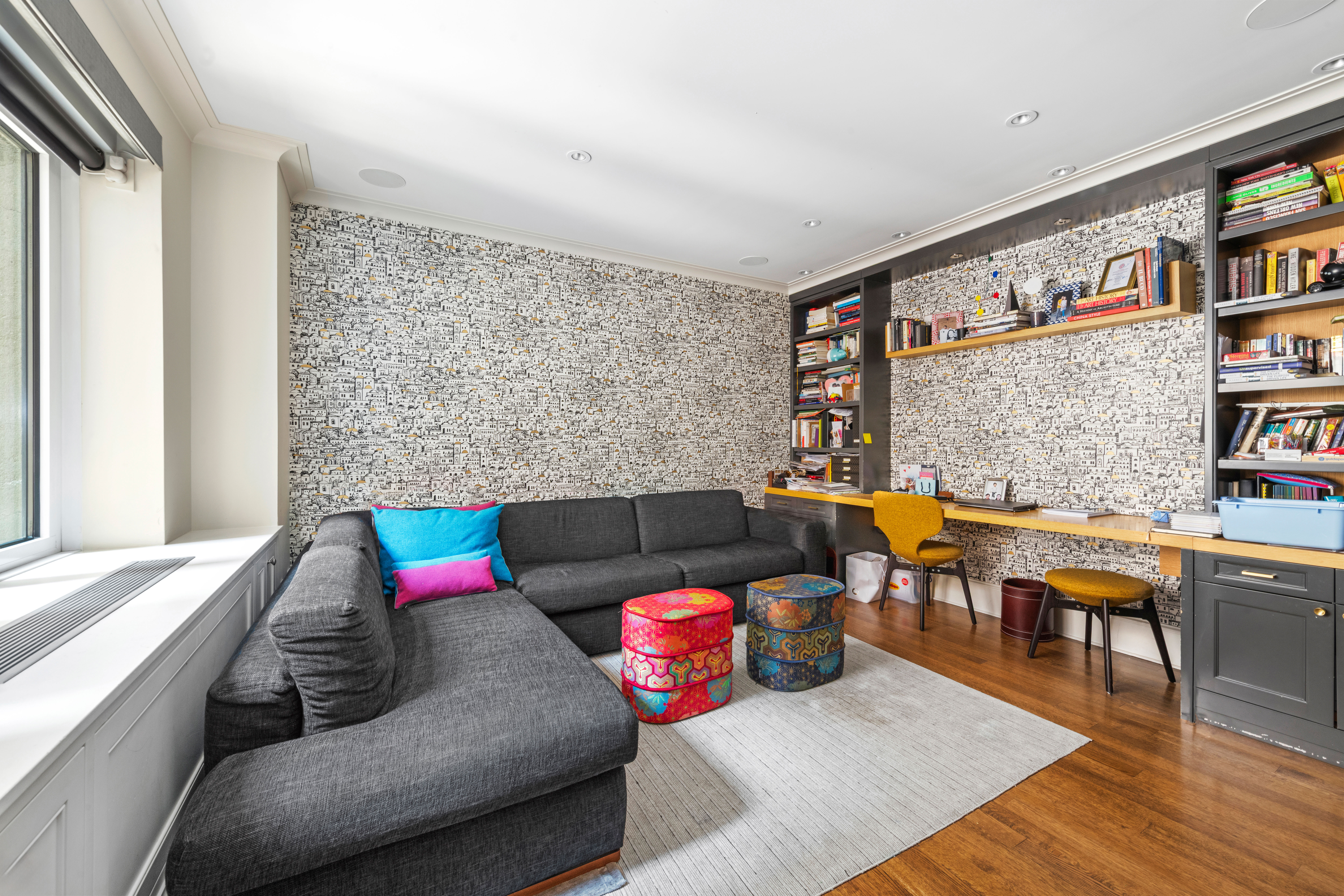 530 Park Avenue, Unit 3F Manhattan, NY 10065 - Photo 14 of 25 a living room with furniture and book shelf