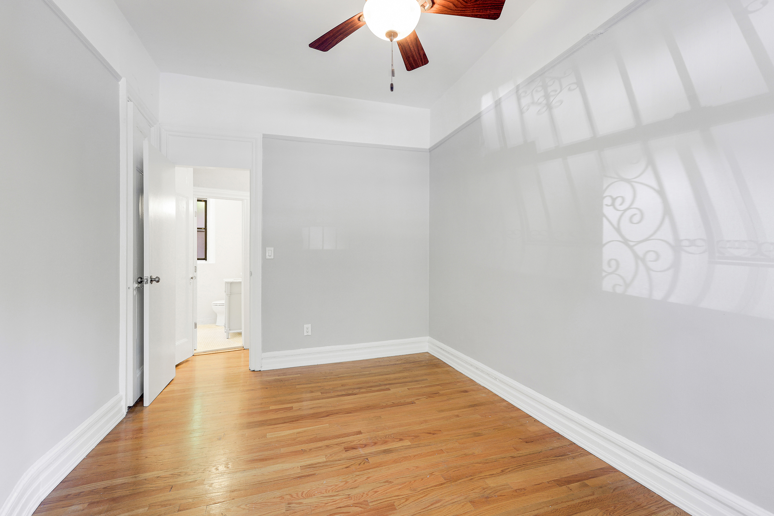 175 Prospect Park Southwest, Unit 1C Brooklyn, NY 11218 - Photo 3 of 12 a view of an empty room with wooden floor