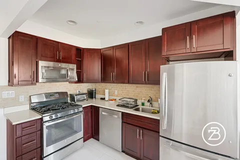 a kitchen with a refrigerator stove and microwave