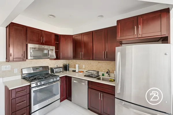 a kitchen with a refrigerator stove and microwave