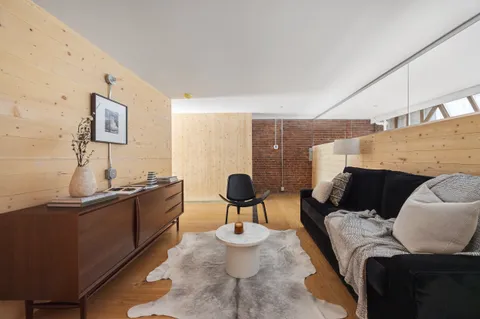 a kitchen with refrigerator and chairs