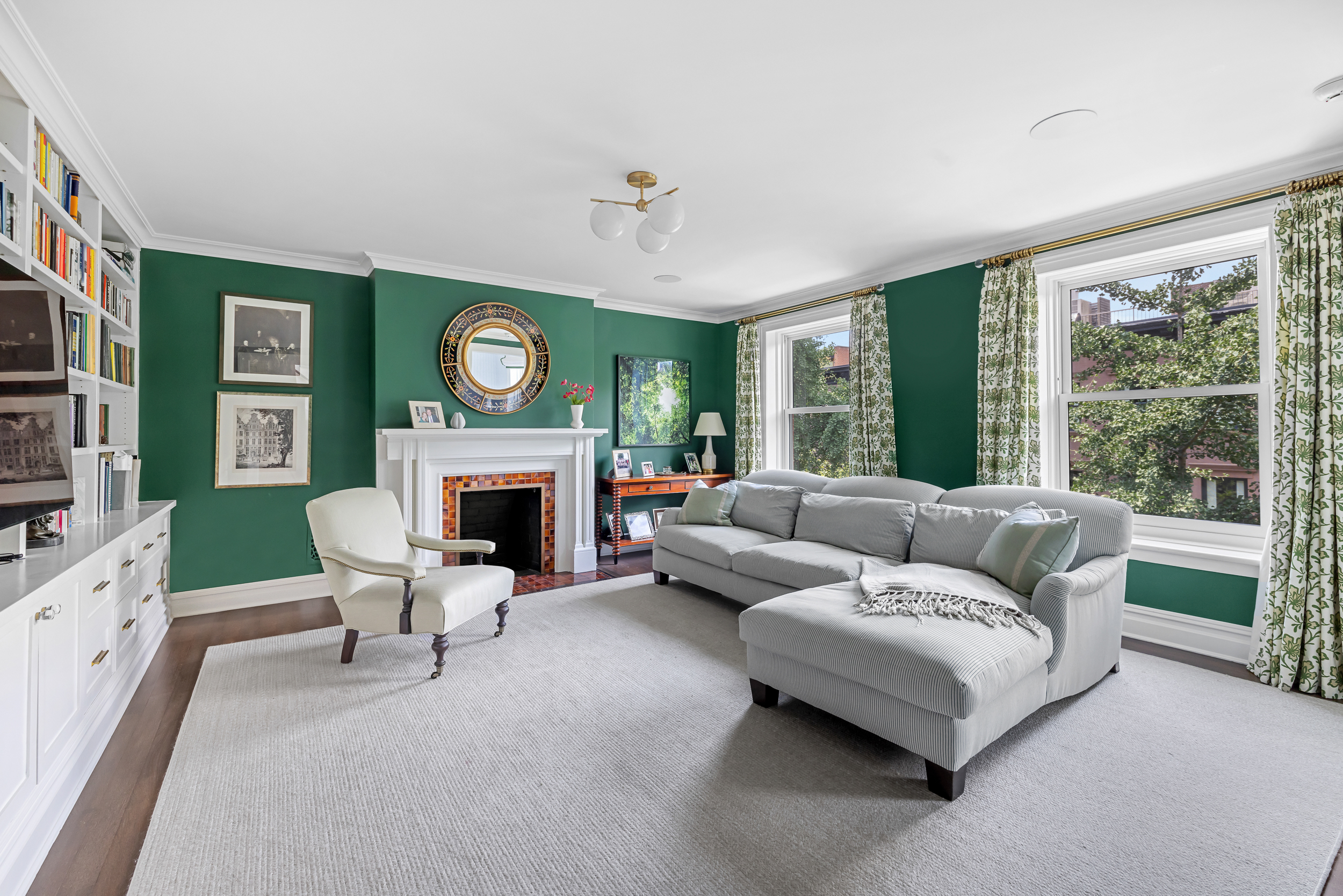 13 Garden Place, Unit B Brooklyn, NY 11201 - Photo 9 of 22 a living room with furniture a large window and a fireplace