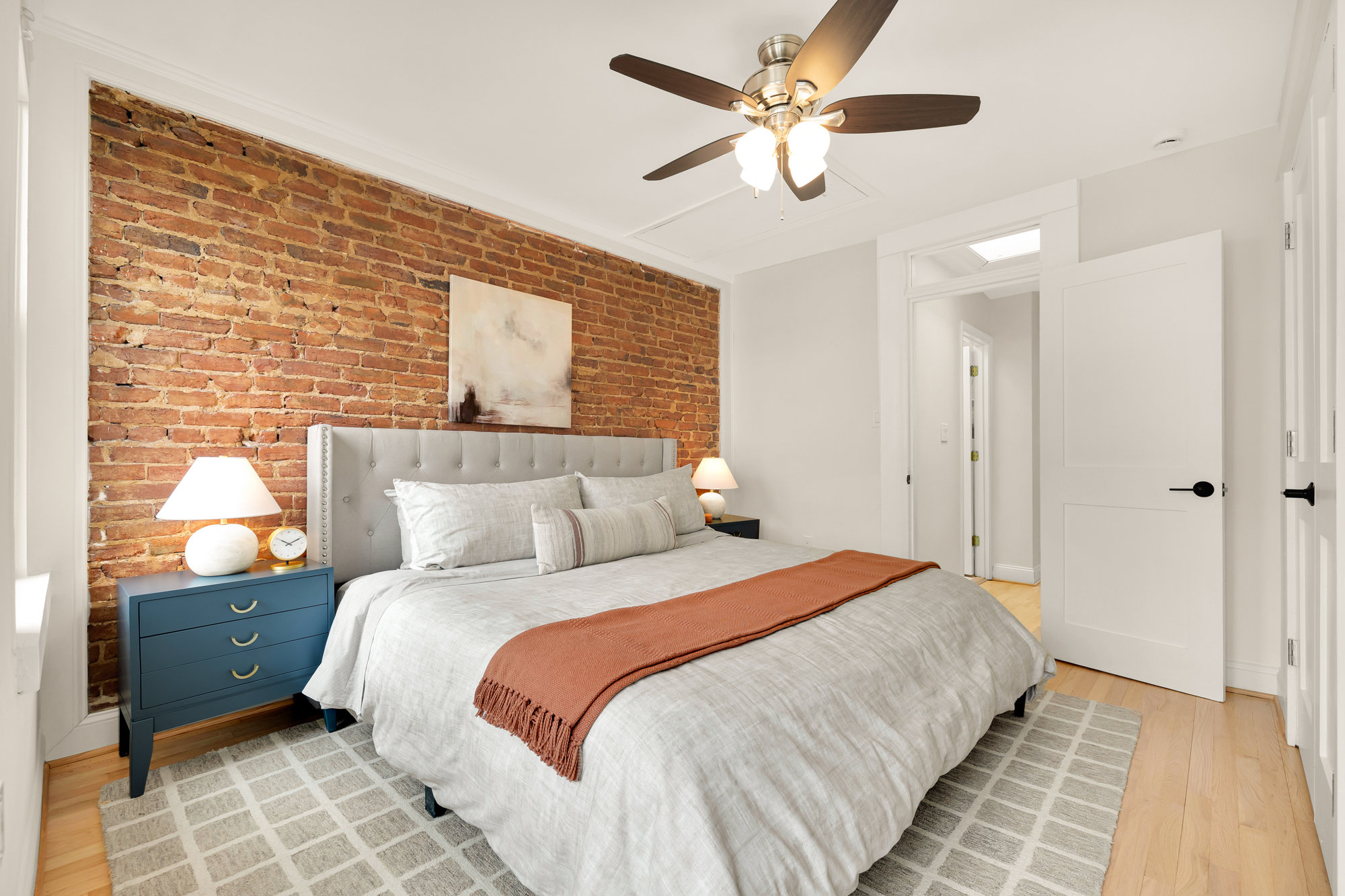 903 F Street Northeast Washington, DC 20002 - Photo 19 of 41 a bedroom with a large bed and a ceiling fan