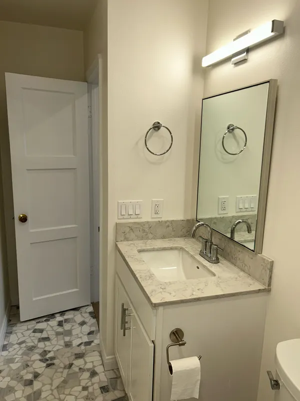 a bathroom with a sink and a mirror