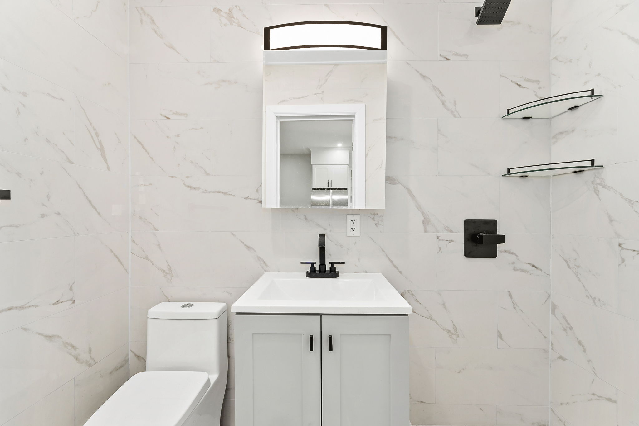 1414 30th Road Queens, NY 11102 - Photo 5 of 16 a bathroom with a sink vanity mirror and toilet