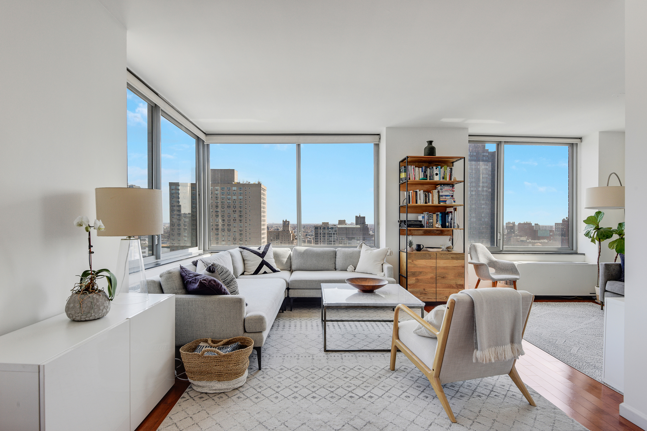 360 East 88th Street, Unit 22C Manhattan, NY 10128 - Photo 4 of 33 a living room with furniture and a potted plant
