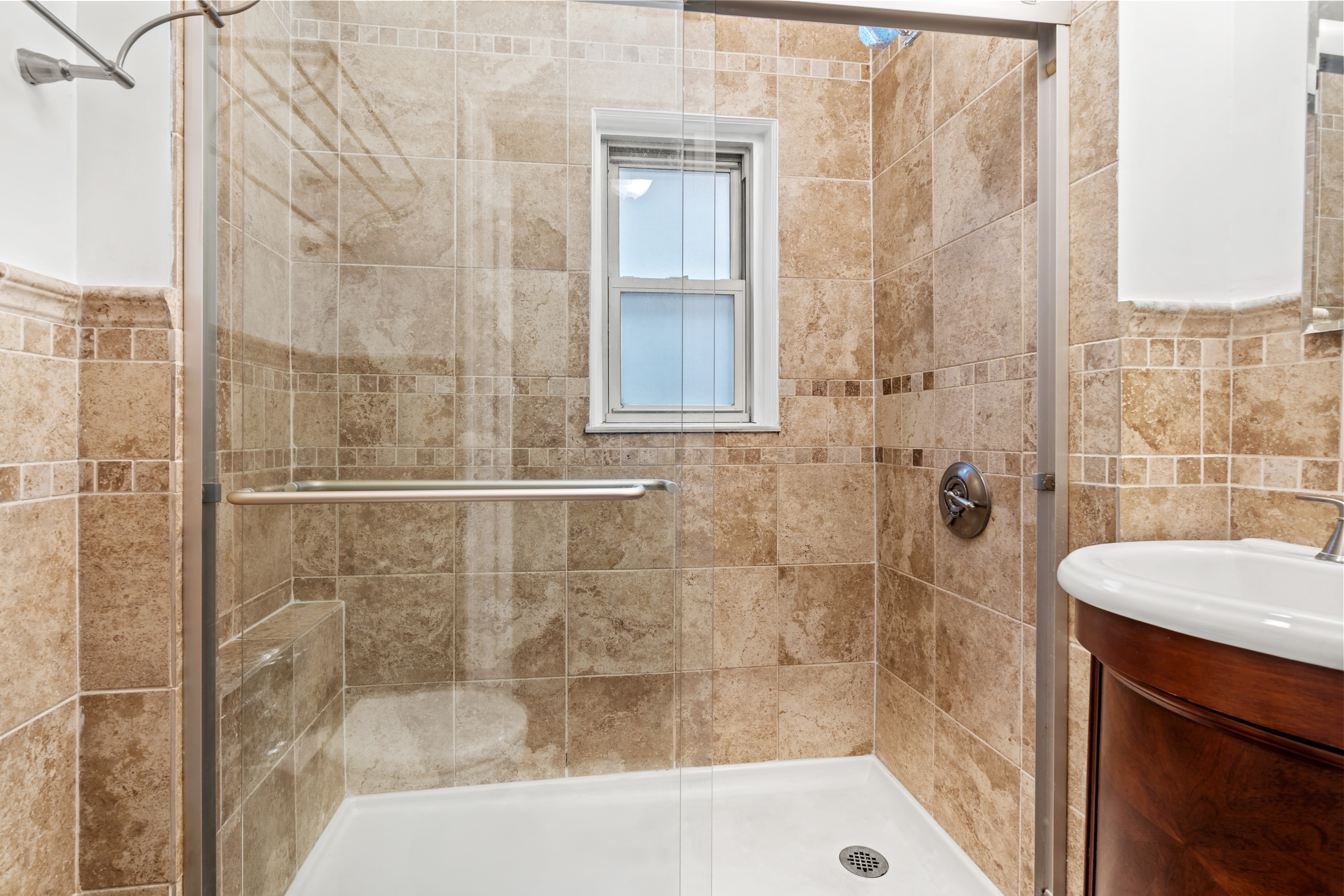 155 East 49th Street, Unit 8C Manhattan, NY 10017 - Photo 7 of 10 a bathroom with a shower and a sink