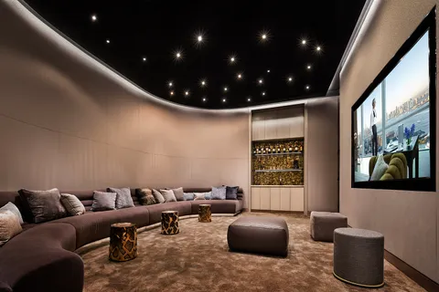 a media room with lots of chairs and a projector screen