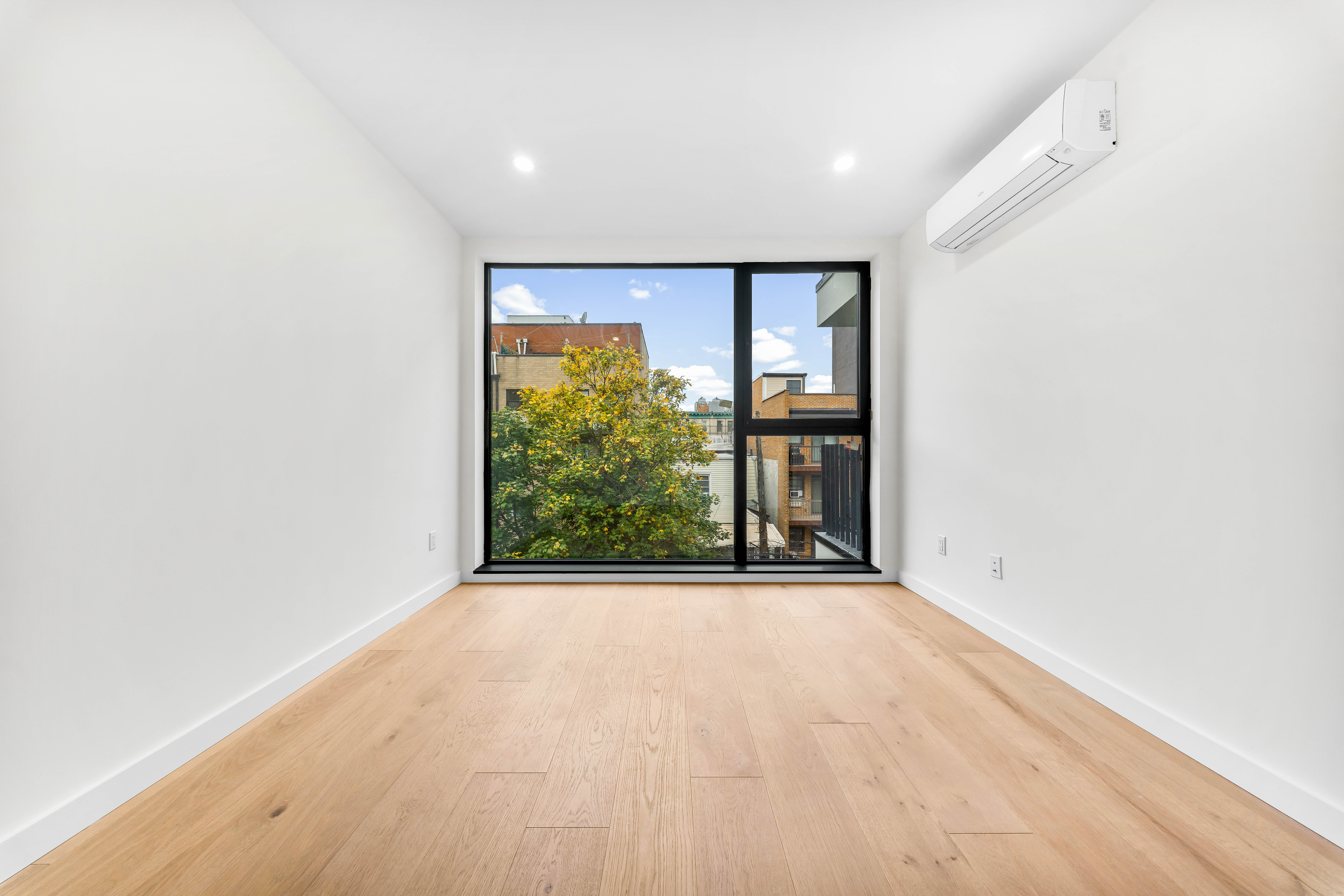 30-24 32nd Street, Unit 3A Queens, NY 11102 - Photo 11 of 18 a view of an empty room with a window