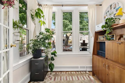 a white bath tub sitting in a bathroom next to a window