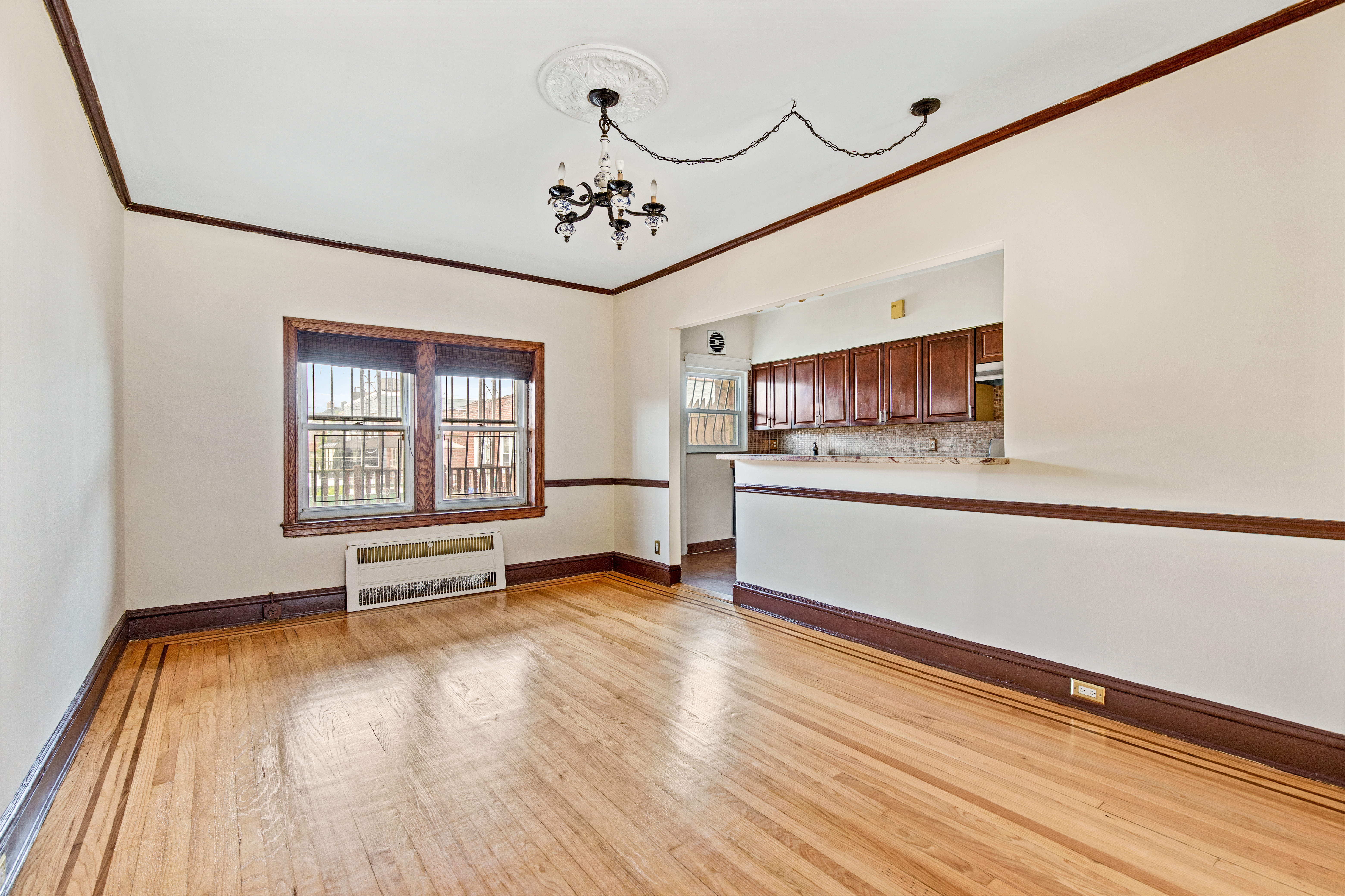32 Tudor Terrace Brooklyn, NY 11224 - Photo 5 of 15 a view of an empty room with a window and wooden floor