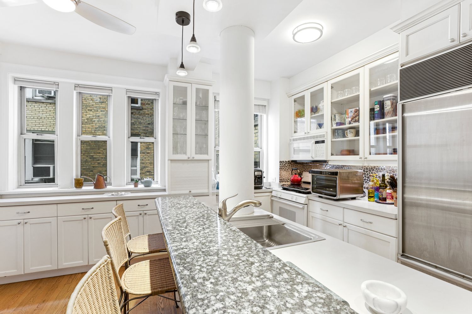 a kitchen with stainless steel appliances granite countertop a sink and a refrigerator