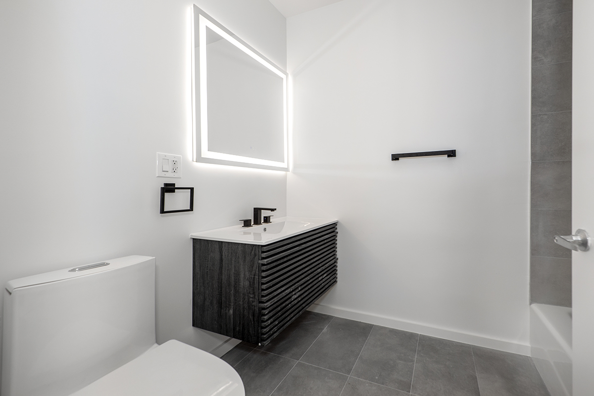 148 North 10th Street, Unit 5A Brooklyn, NY 11249 - Photo 7 of 9 a bathroom with a sink toilet and mirror
