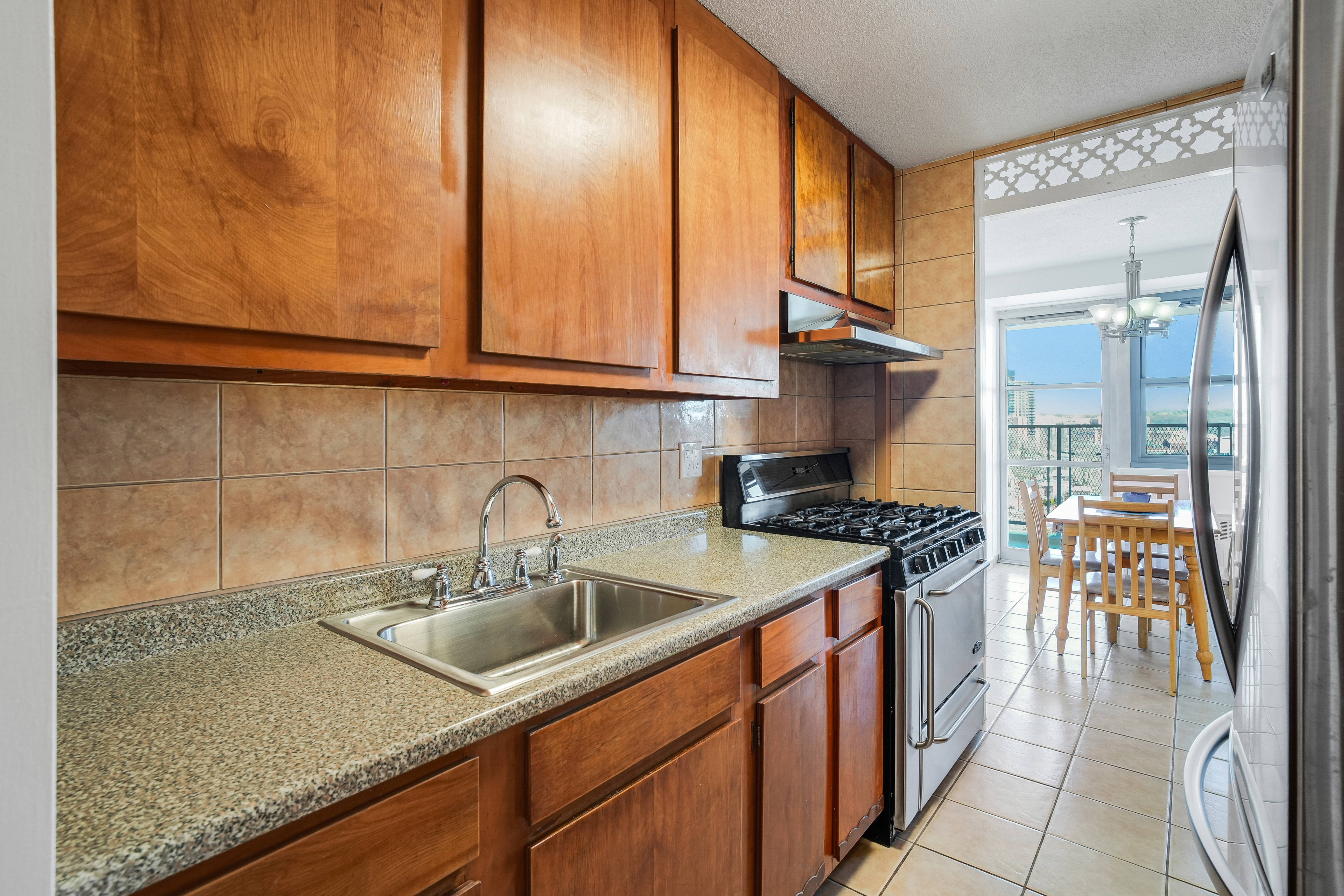 290 West 232nd Street, Unit 18B Bronx, NY 10463 - Photo 6 of 16 a kitchen with stainless steel appliances granite countertop a sink and a refrigerator