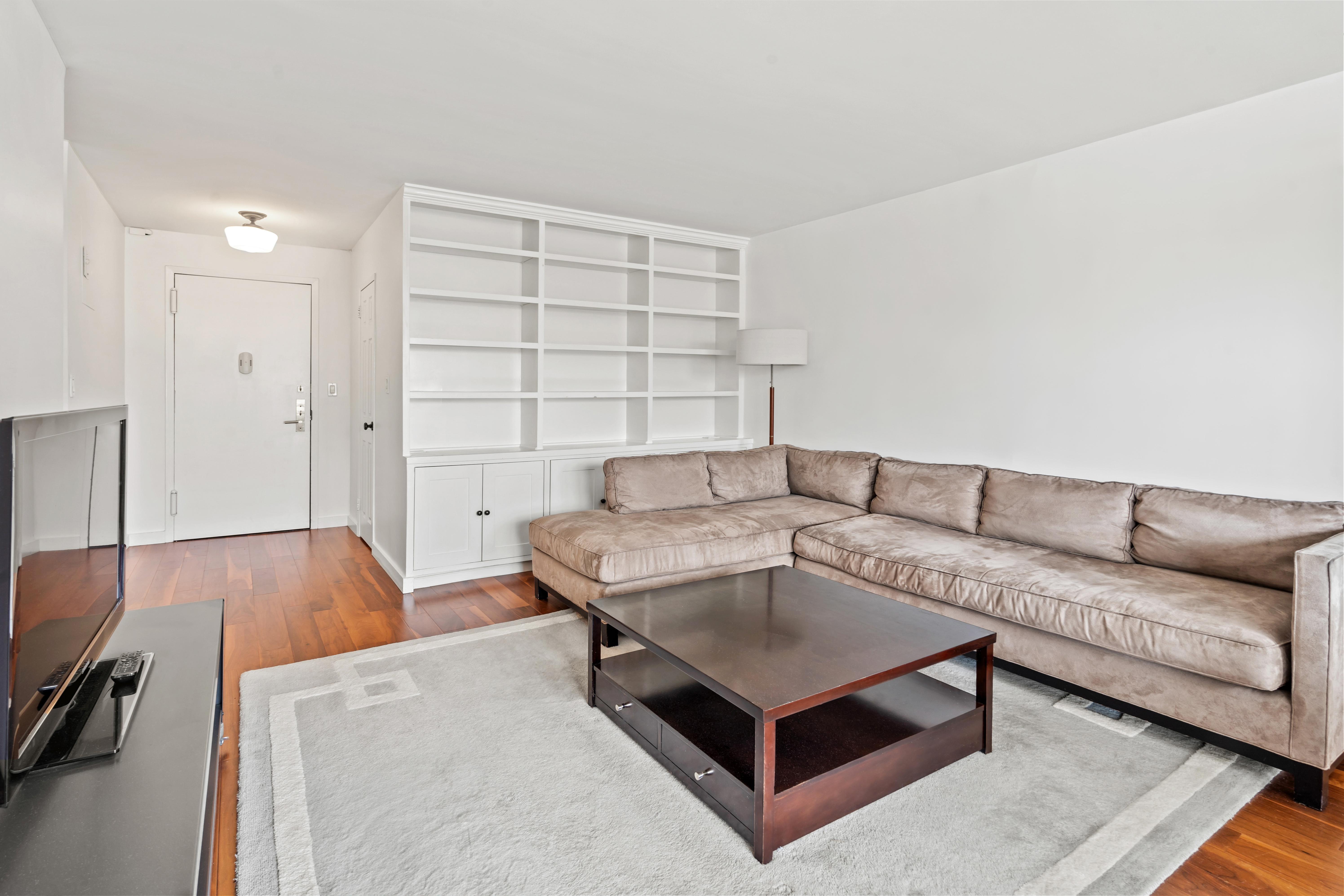 205 3rd Avenue, Unit 11T Manhattan, NY 10003 - Photo 5 of 20 a living room with furniture and a wooden floor