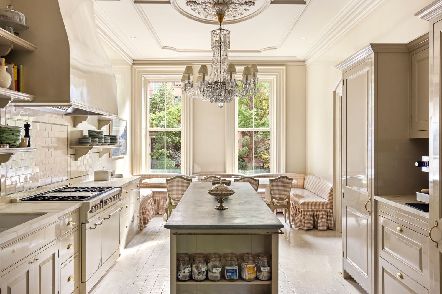 a kitchen with stainless steel appliances a sink a stove and a chandelier