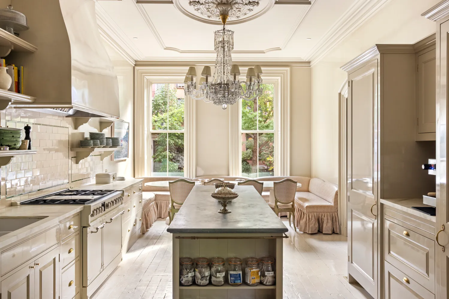 a kitchen with stainless steel appliances a sink a stove and a chandelier