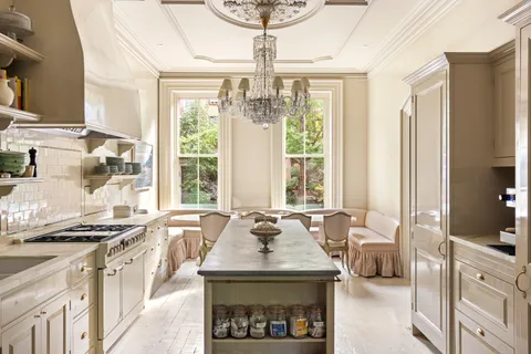 a kitchen with stainless steel appliances a sink a stove and a chandelier