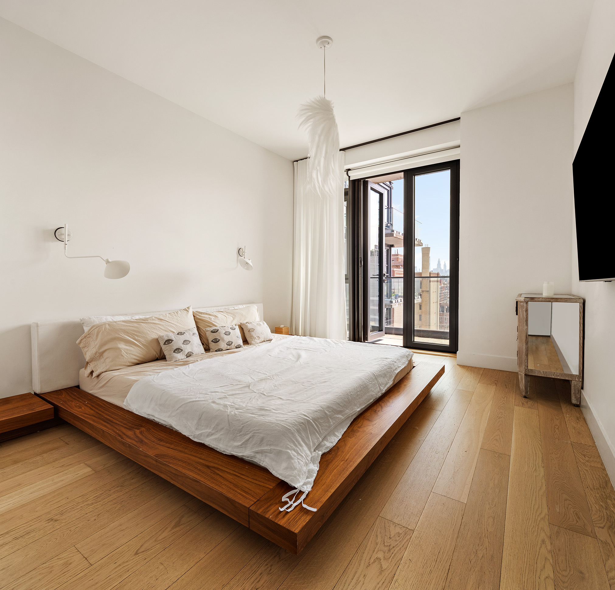 11 Hancock Place, Unit PH102 Manhattan, NY 10027 - Photo 5 of 18 a bedroom with a bed lamp and a large window