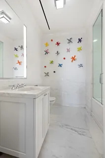 a bathroom with a shower sink and mirror