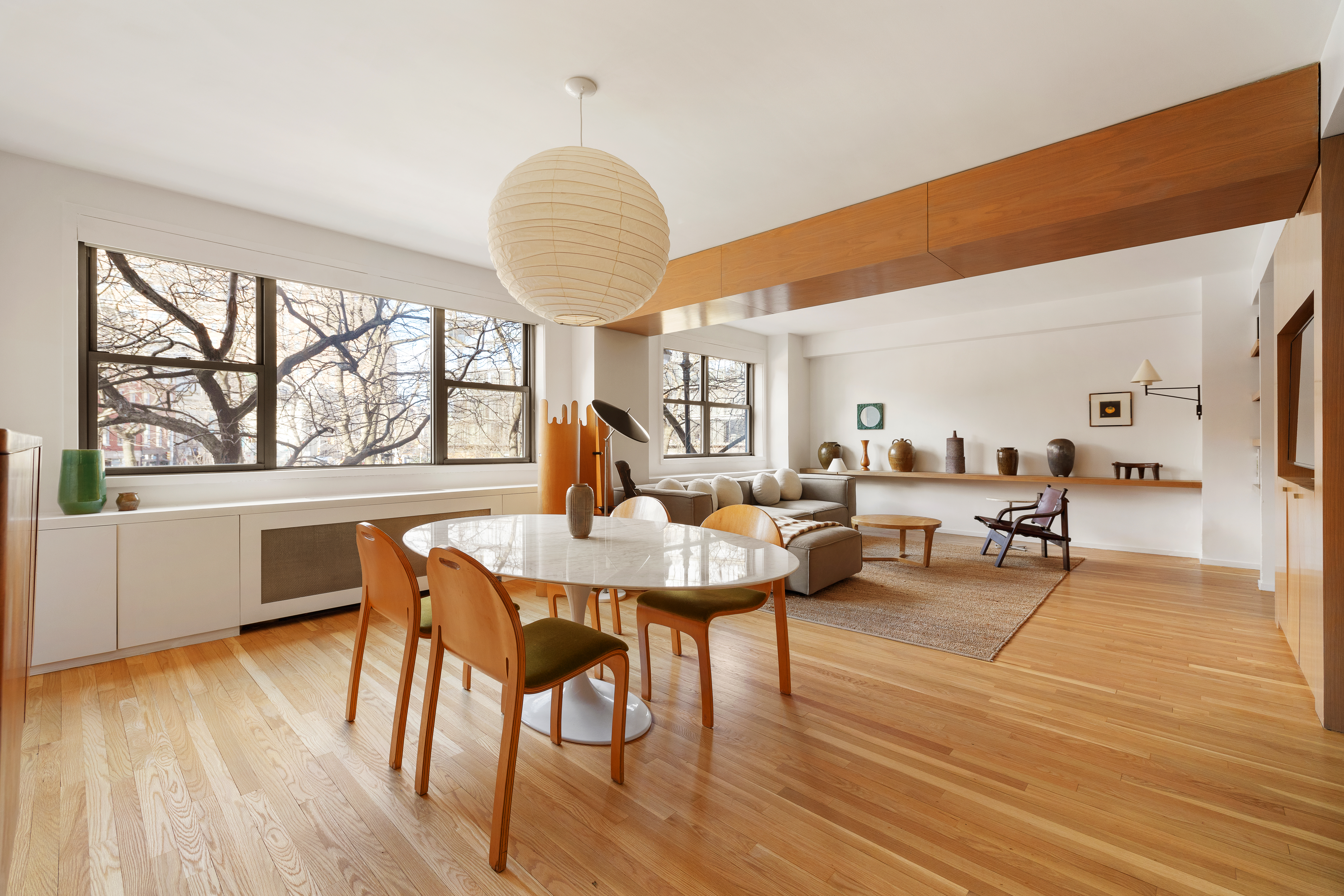 2 Horatio Street, Unit 2PR Manhattan, NY 10014 - Photo 1 of 14 a living room with furniture a wooden floor and a large window