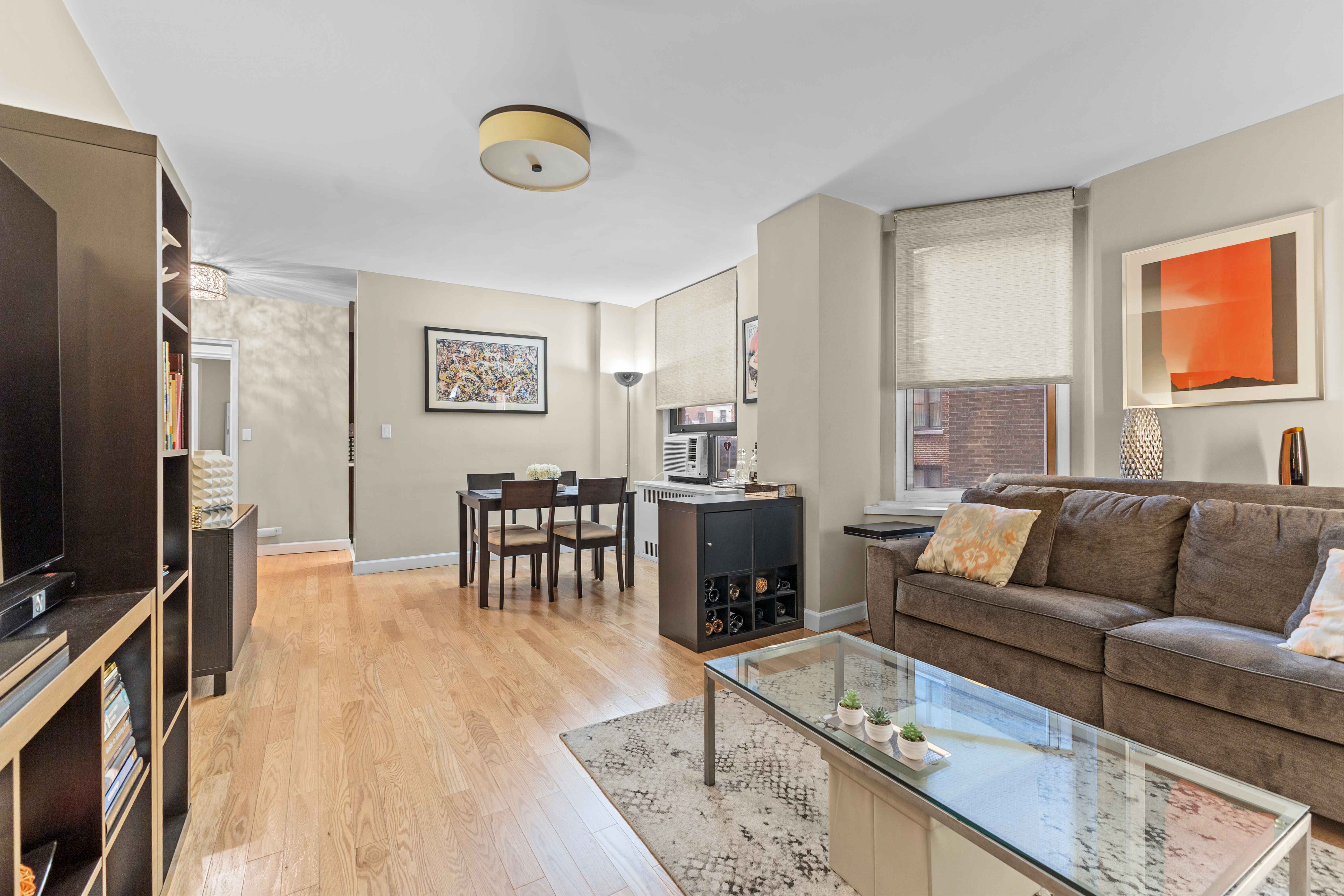 263 West End Avenue, Unit 6E Manhattan, NY 10023 - Photo 1 of 12 a living room with furniture and a flat screen tv