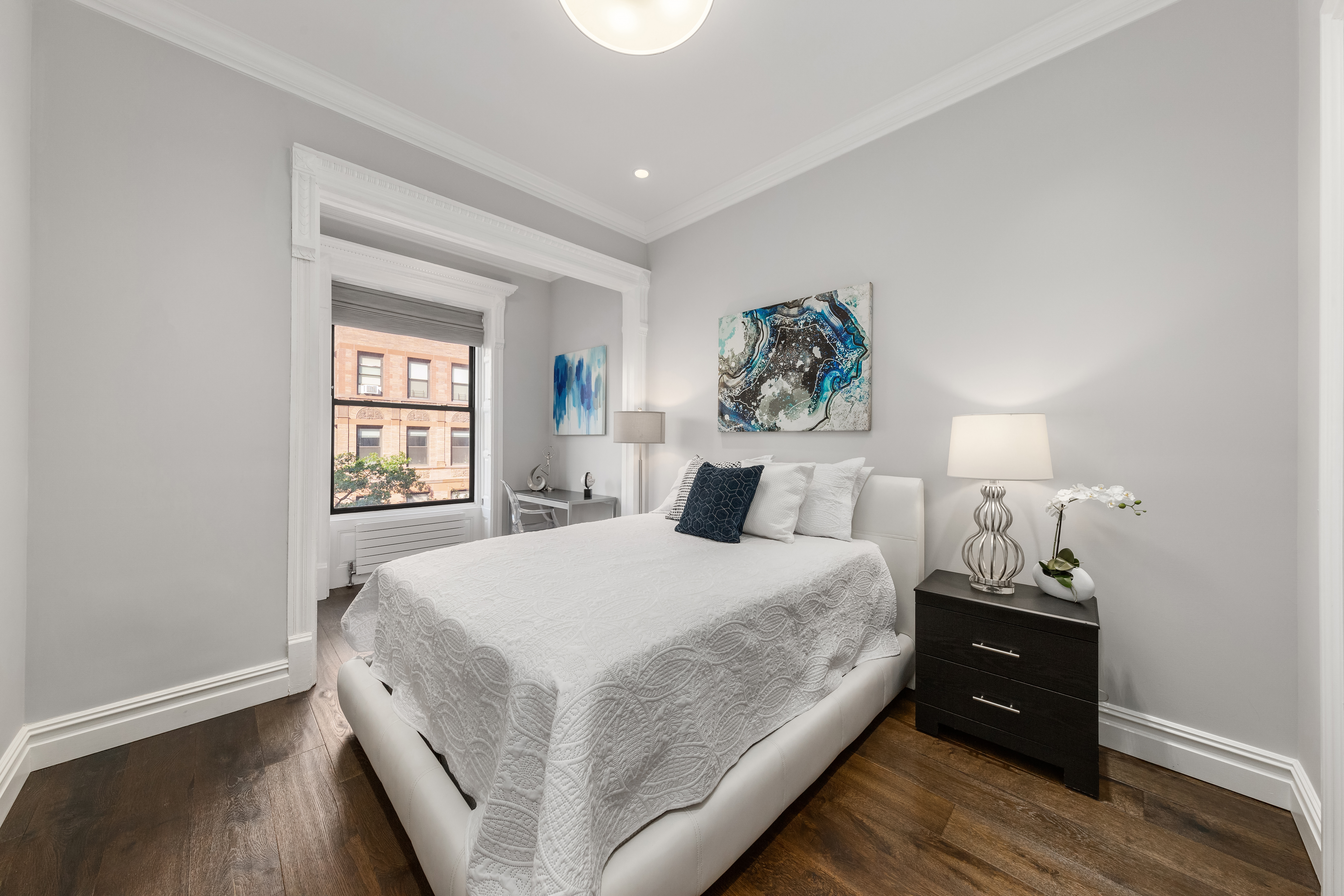 110 West 81st Street Manhattan, NY 10024 - Photo 9 of 30 a bedroom with a bed and a window