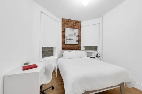 a bedroom with a bed and a cabinets