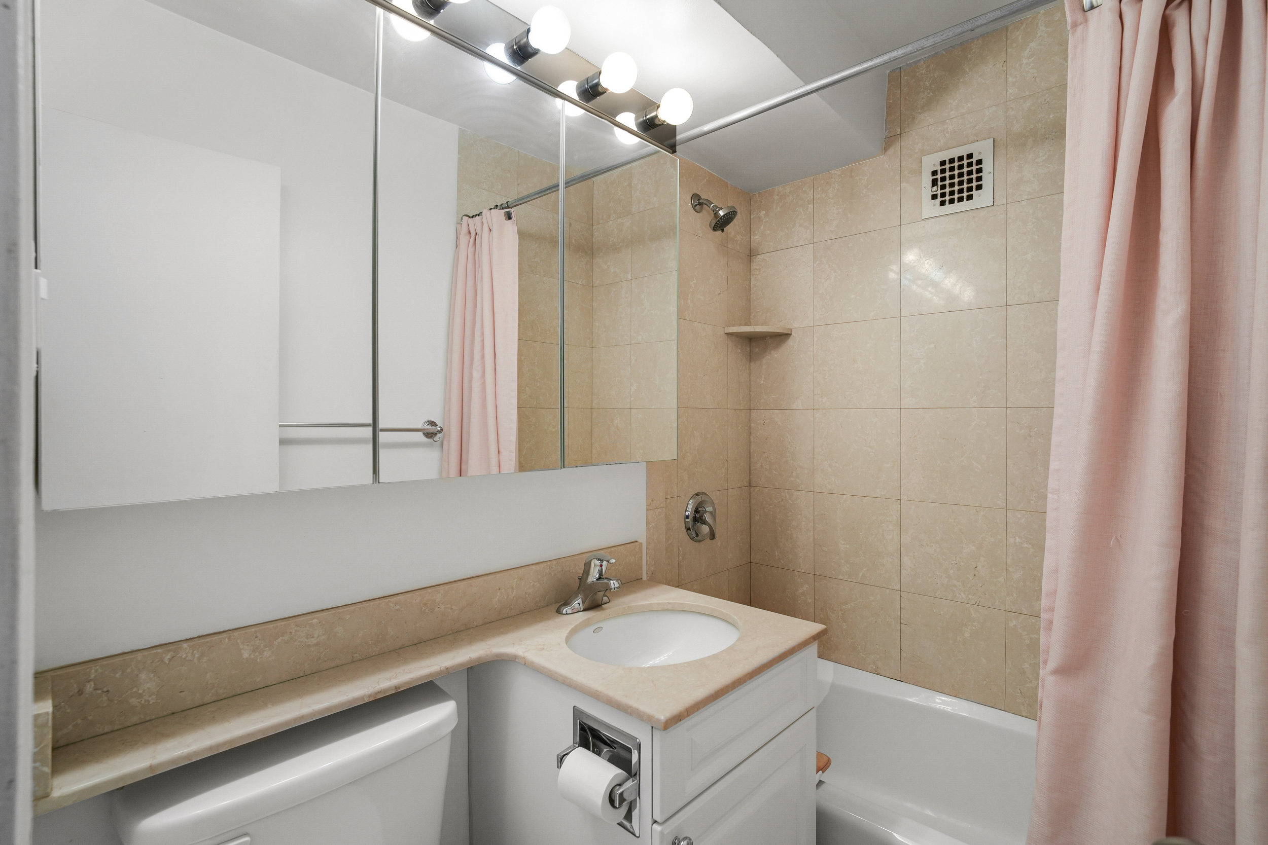 240 East 76th Street, Unit 10L Manhattan, NY 10021 - Photo 5 of 9 a bathroom with a sink and a mirror