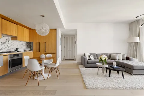 a living room with furniture a large window and a fireplace