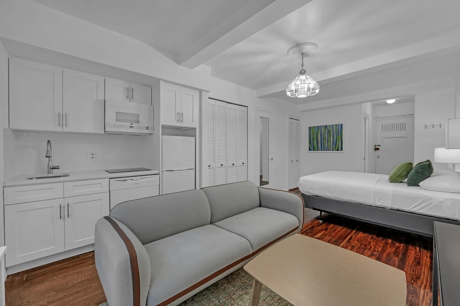 a living room with furniture a chandelier and a rug