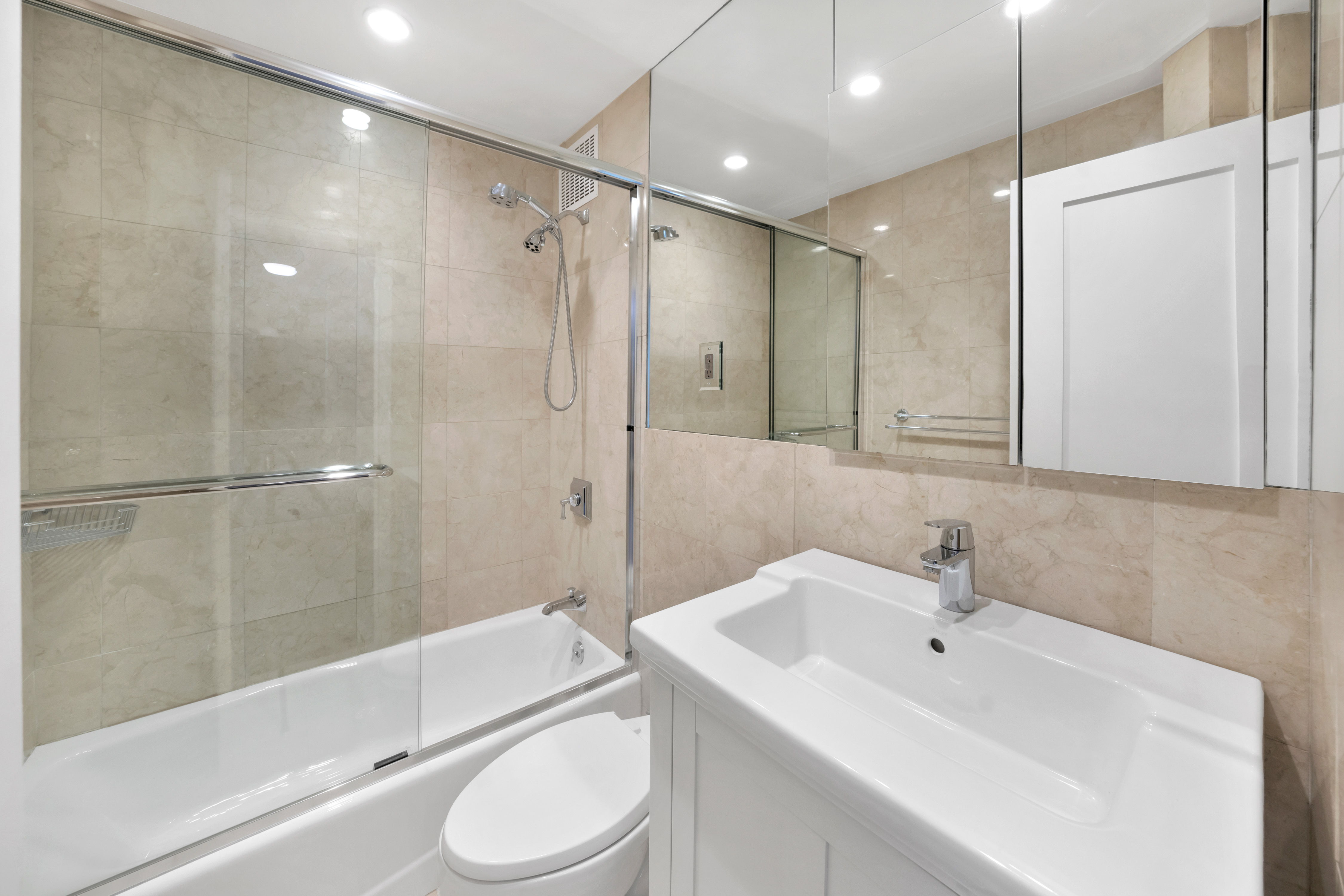 2 Tudor City Place, Unit 9OS Manhattan, NY 10017 - Photo 6 of 11 a bathroom with a sink toilet and shower