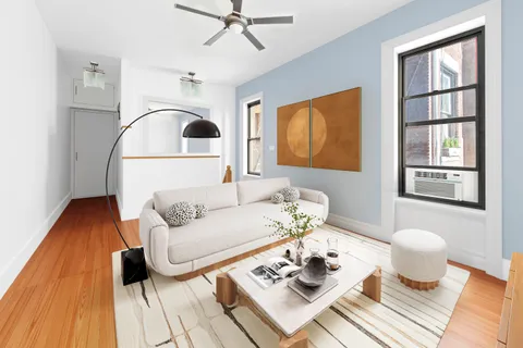 a living room with furniture and wooden floor