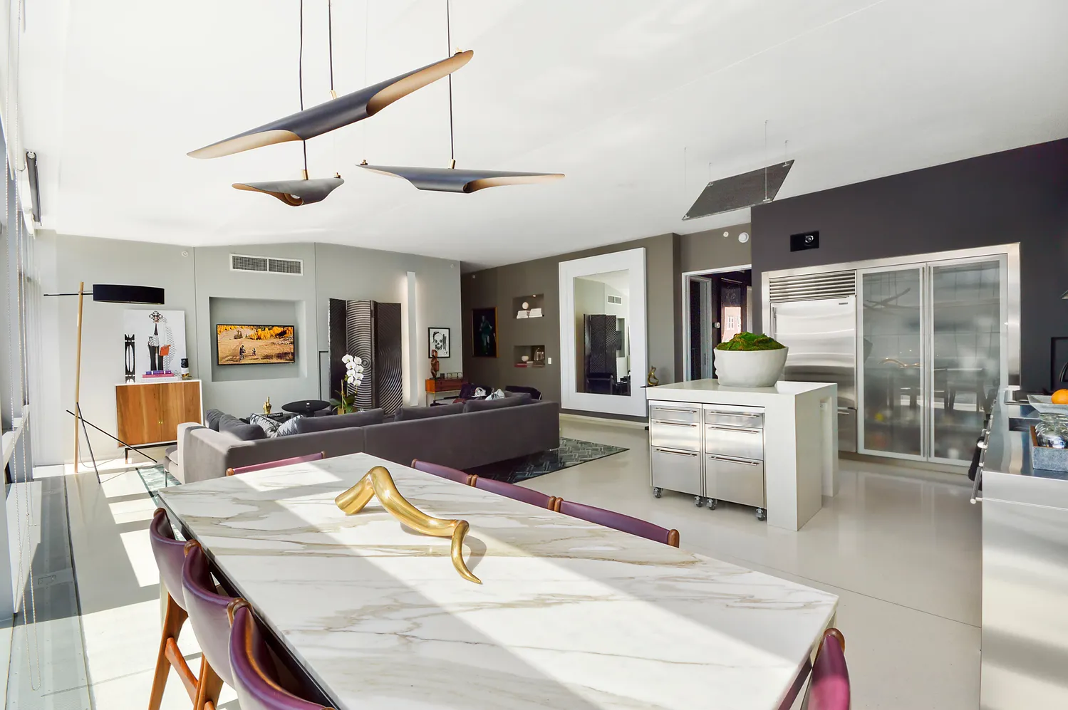 a living room with stainless steel appliances kitchen island granite countertop furniture and a kitchen view