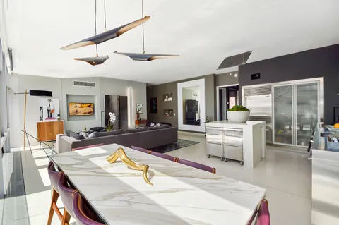 a living room with stainless steel appliances kitchen island granite countertop furniture and a kitchen view