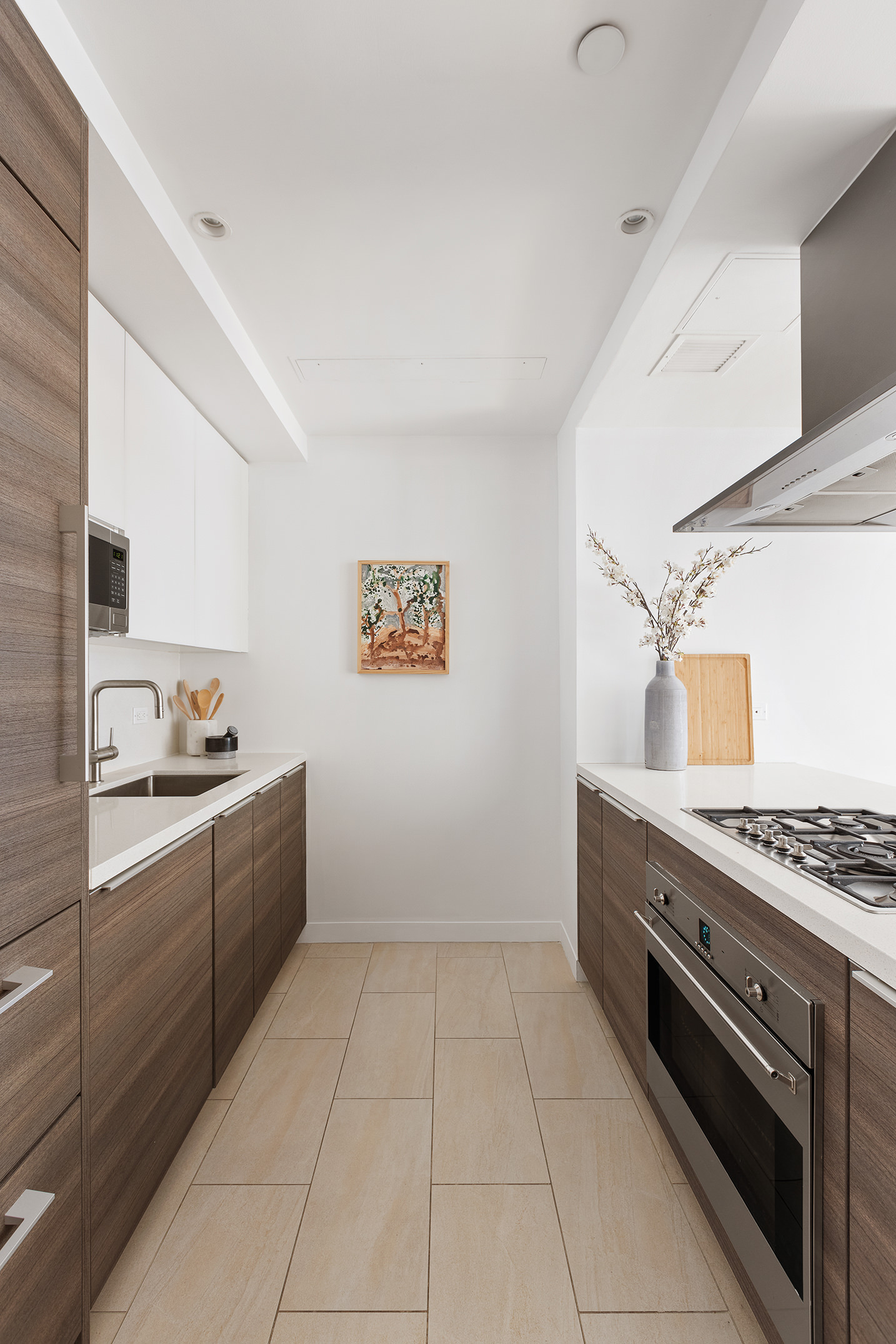 151 West 21st Street, Unit 9C Manhattan, NY 10011 - Photo 5 of 10 a kitchen with stainless steel appliances granite countertop a stove and a sink