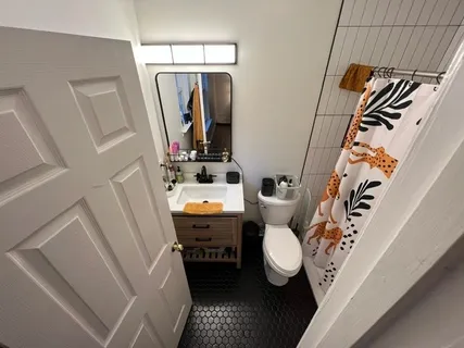 a bathroom with a sink toilet and shower