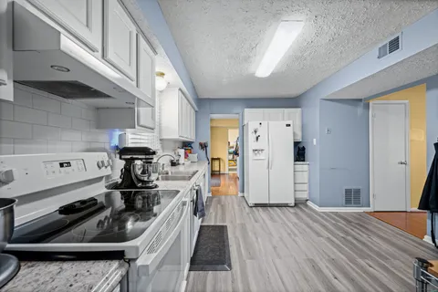 a kitchen with a stove and a refrigerator