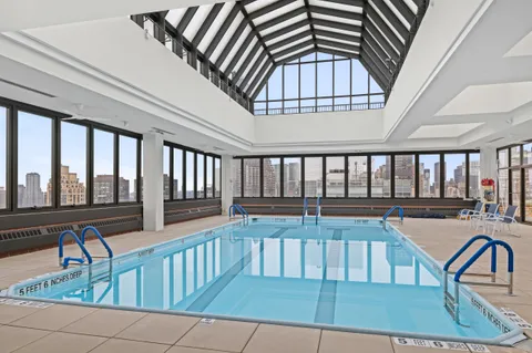 a view of a swimming pool with seating space