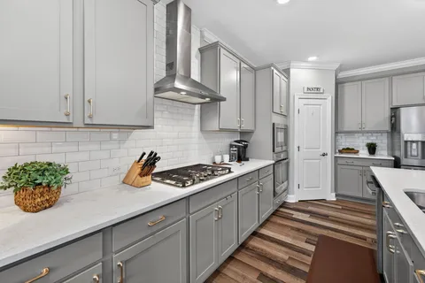a kitchen with stainless steel appliances a sink stove and cabinets