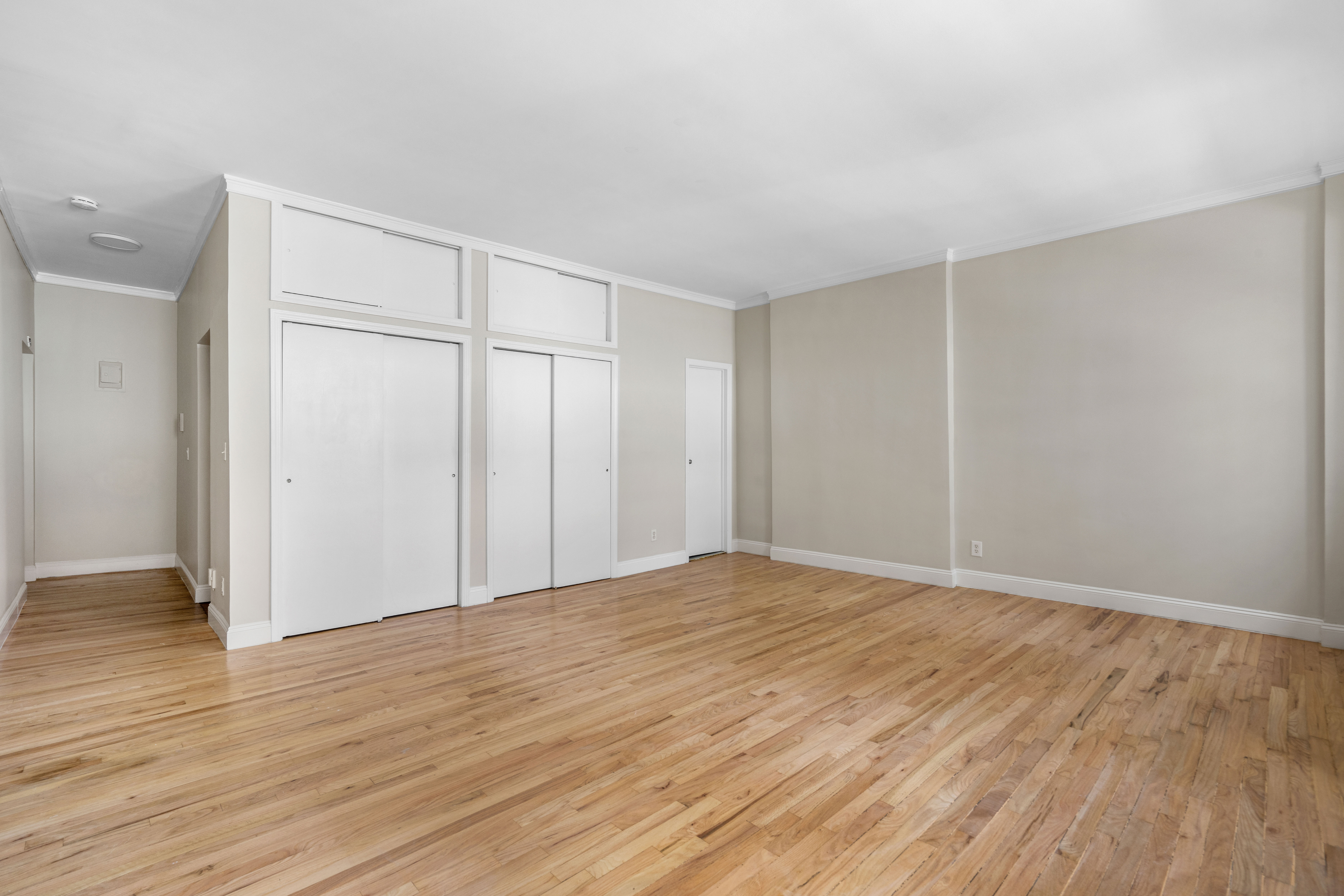 236 West 52nd Street, Unit B1 Manhattan, NY 10019 - Photo 2 of 15 a view of an empty room and wooden floor