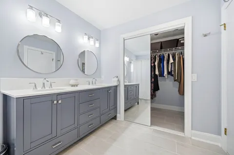 a spacious bathroom with a double vanity sink double and a mirror