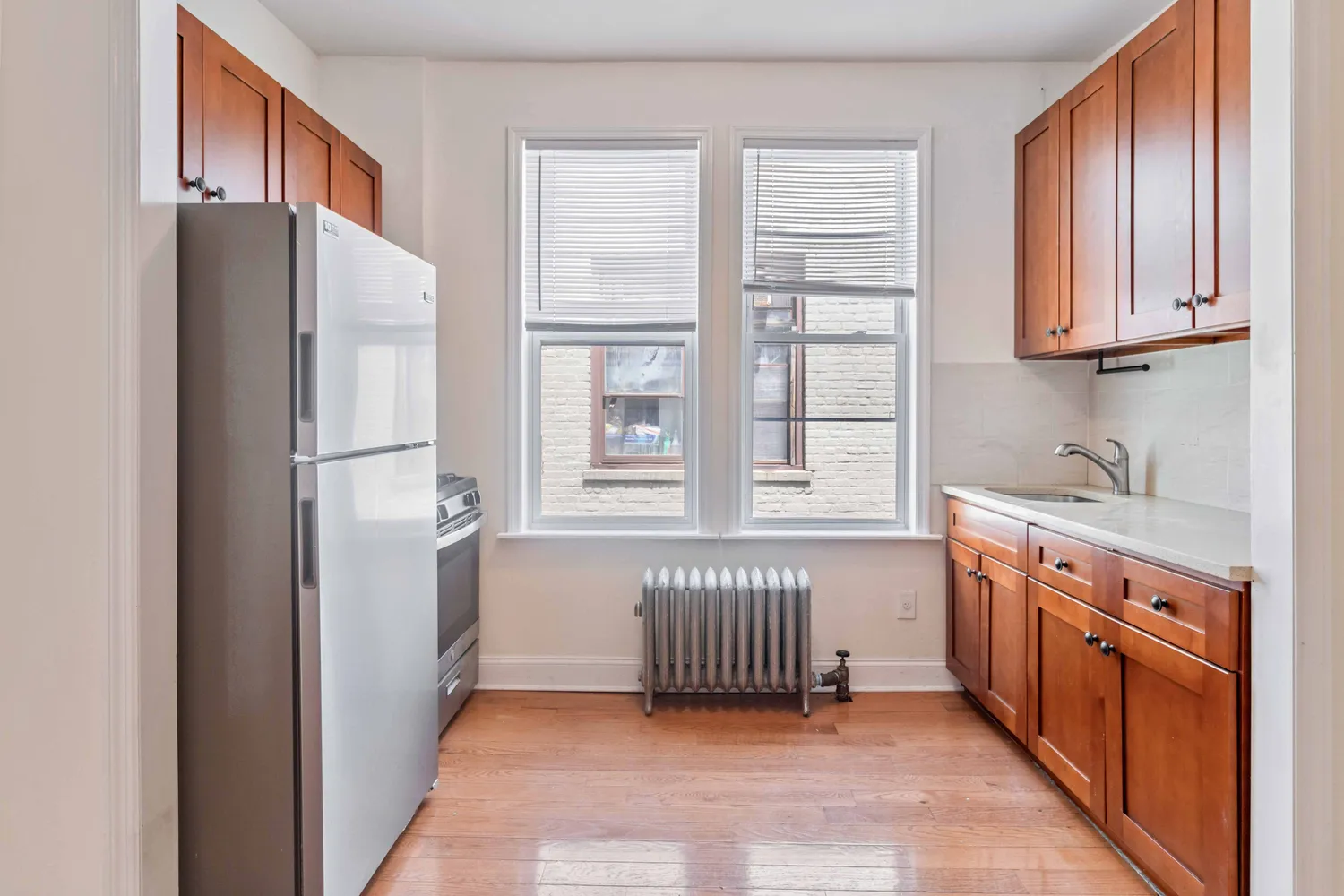 a kitchen with stainless steel appliances granite countertop a refrigerator and a sink